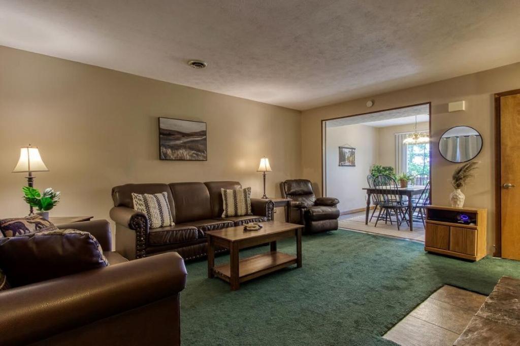 a living room with a couch and a table at Pool-Pinecrest Townhomes-1KING 2BUNK UNIT in Pigeon Forge