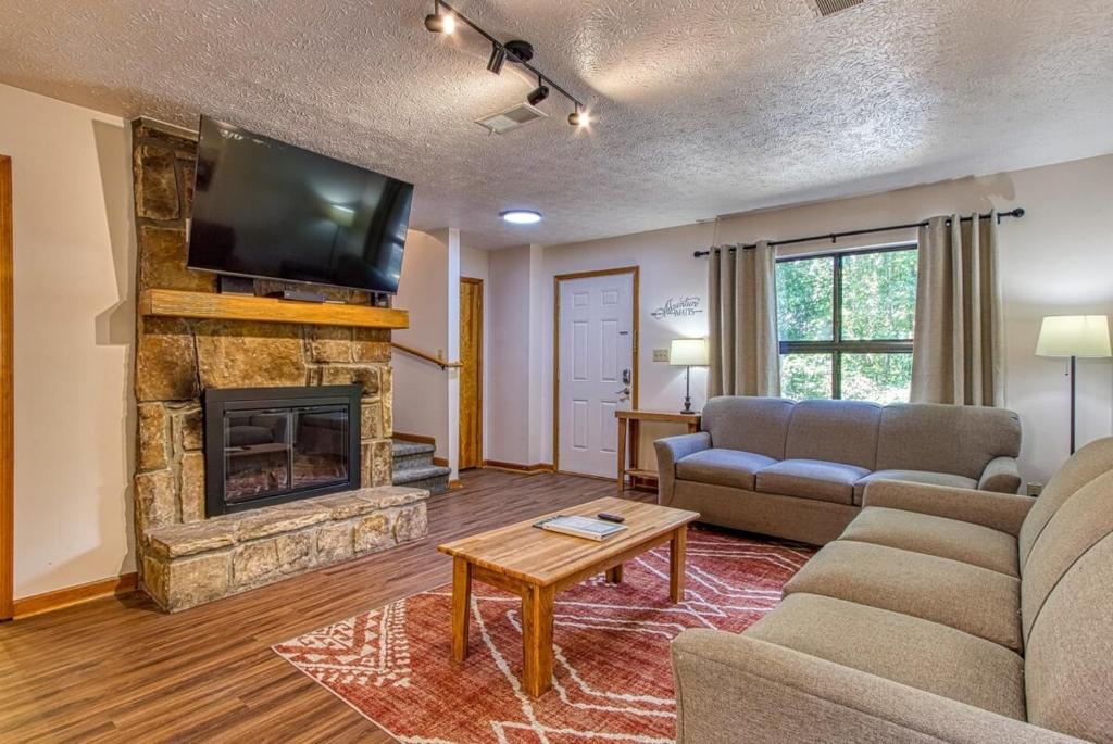a living room with a couch and a fireplace at Pool-Pinecrest Townhomes-1King2Queen- RENOVATED in Pigeon Forge