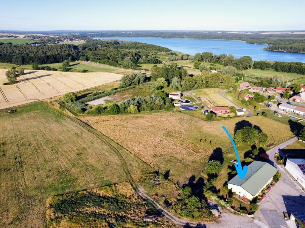 an aerial view of a farm with a lake at Ferienwohnung Feldblick auf dem Bauernhof am Schweriner See in Bad Kleinen