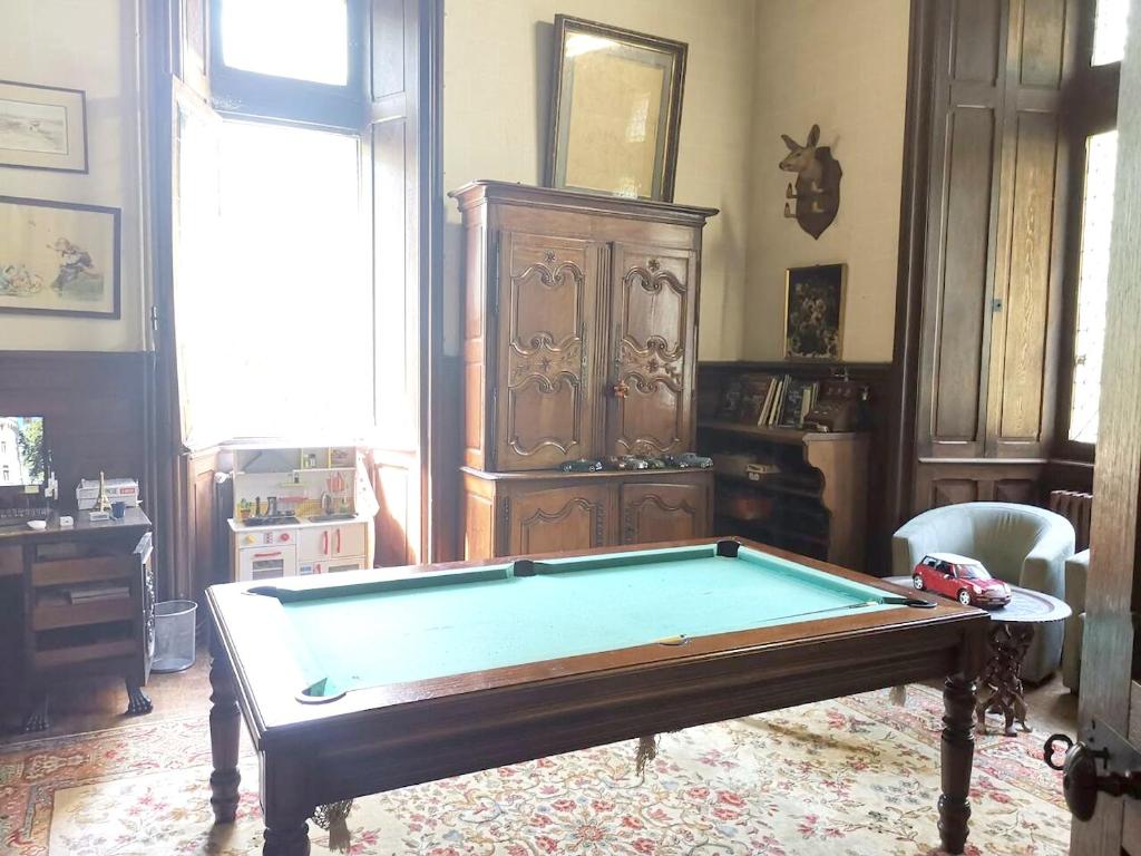 a living room with a pool table in it at Demeure de 7 chambres avec piscine privee terrasse et wifi a Mosnay in Mosnay