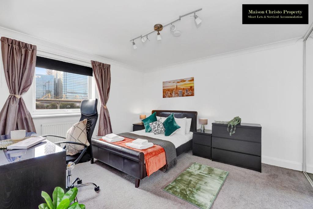 a bedroom with a bed and a desk and a chair at Caraway Heights 2Bedroom Apt Sleeps 6 in Canary Wharf, London with Free Parking, Wifi & Leisure By Maison Christo Property Short Lets & Serviced Accommodation in London