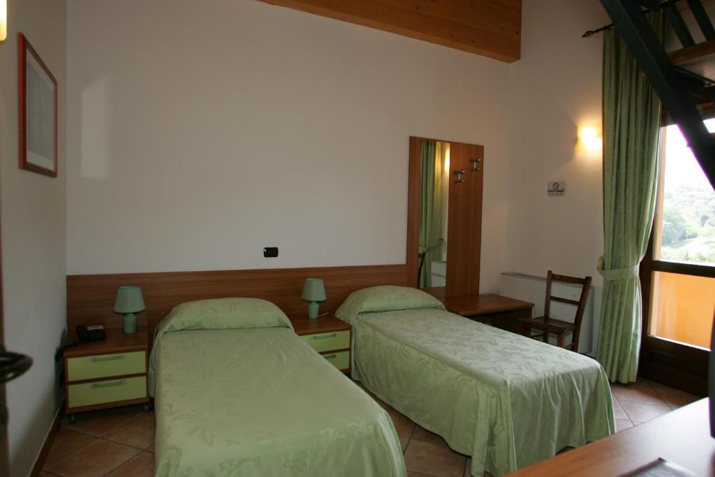 Postel nebo postele na pokoji v ubytování Hotel la Colletta