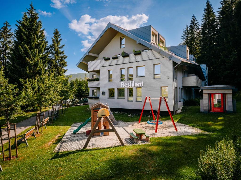 a house with a playground in front of it at Studio Harrachov Resident by Interhome in Harrachov