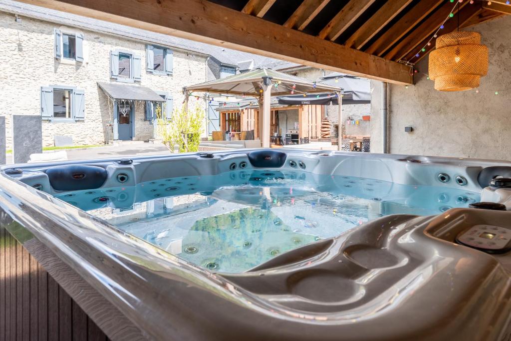 KasaLilou, Grand Gîte de prestige St Lary في Vignec: حوض استحمام ساخن على أرجوحة في الفناء الخلفي