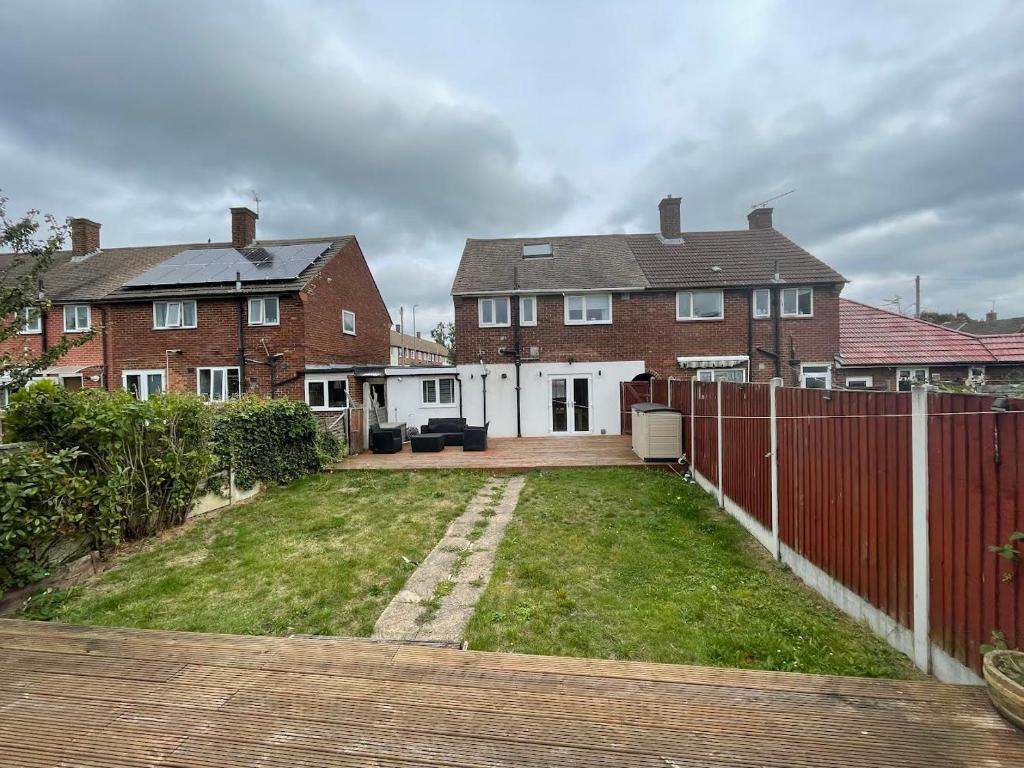 a backyard of a house with a fence at Beautiful 3-Bed House in Romford in Romford