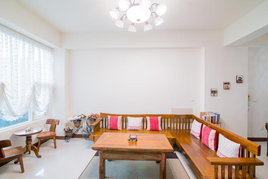 a dining room with a table and chairs and a chandelier at Zhileju Homestay in Hualien City