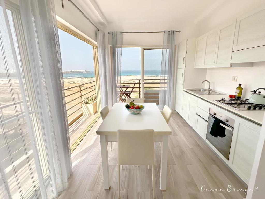 a kitchen with a table and a view of the ocean at Ocean Breeze 9 in Sal Rei
