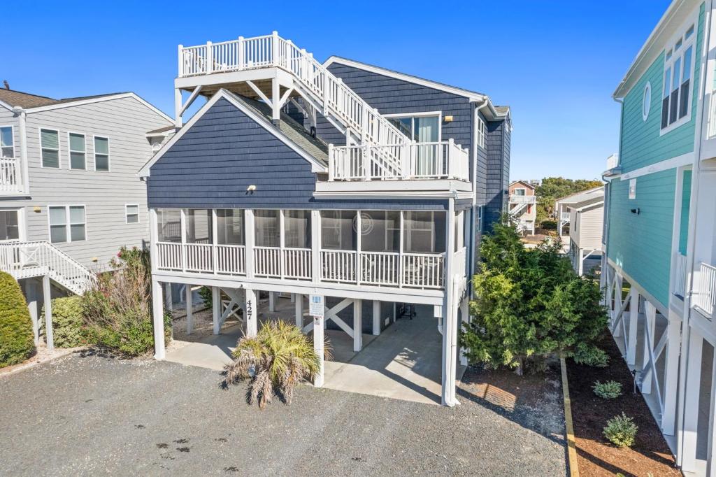 an image of a house with a balcony at Rip Tide I Brunswick Vacation Rentals in Sunset Beach