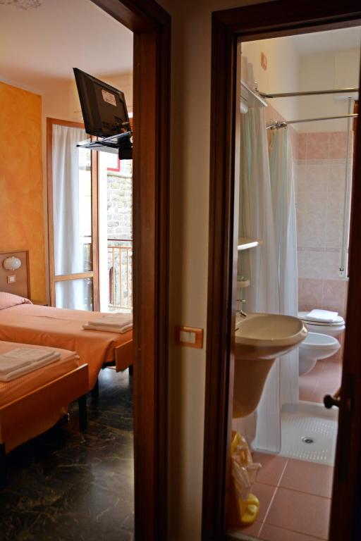 Postel nebo postele na pokoji v ubytování Hotel Corallo
