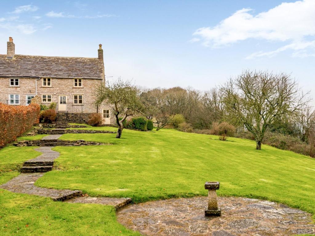 an old stone house with a grassy yard at 4 Bed in Isle of Purbeck 78042 in Kingston