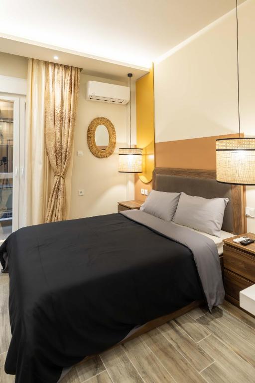 a bedroom with a large black bed and a window at GPX CLR - Guest Apartment No1 in Larisa