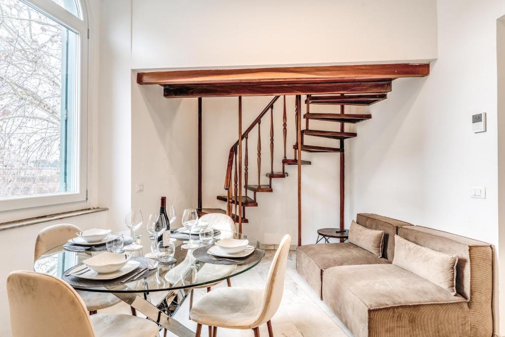 a dining room with a glass table and chairs at V E N E R E Apartments in Rome