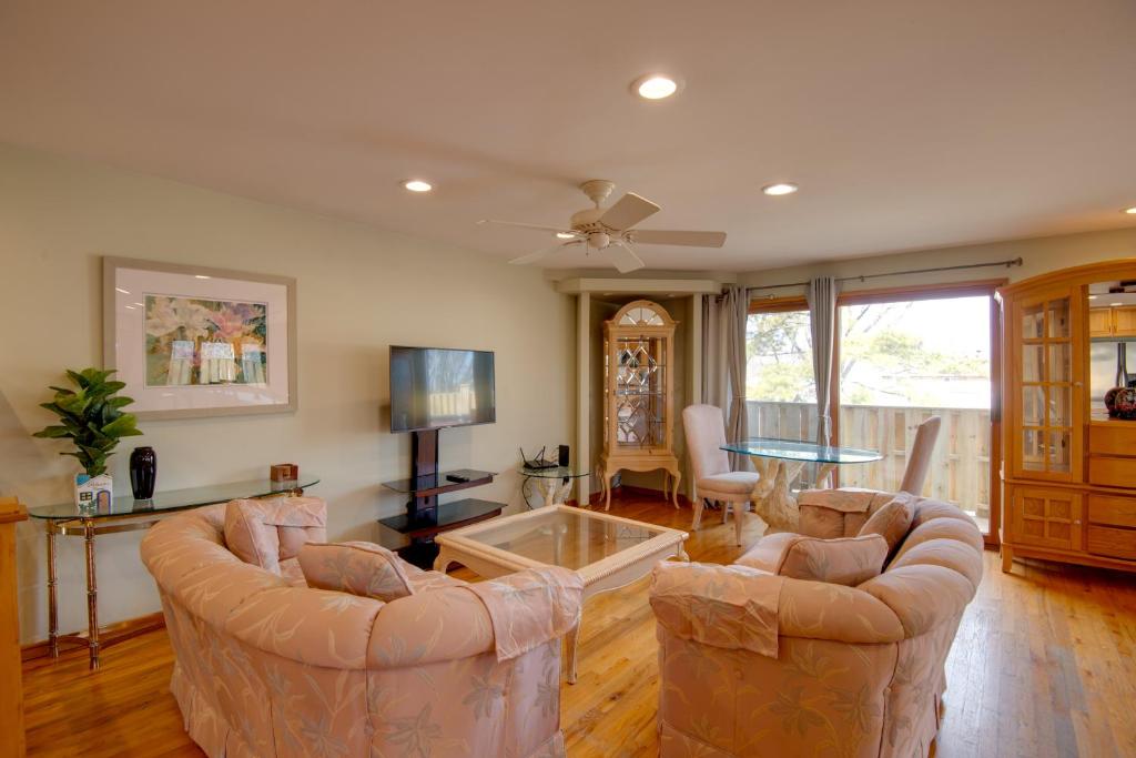 a living room with two couches and a table at Charming Illinois Retreat with Hot Tub, Deck and Grill in Schaumburg