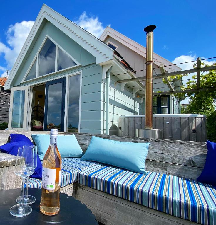 a bottle of wine and a glass on a table at Romantic Dutch hideaway in Jisp