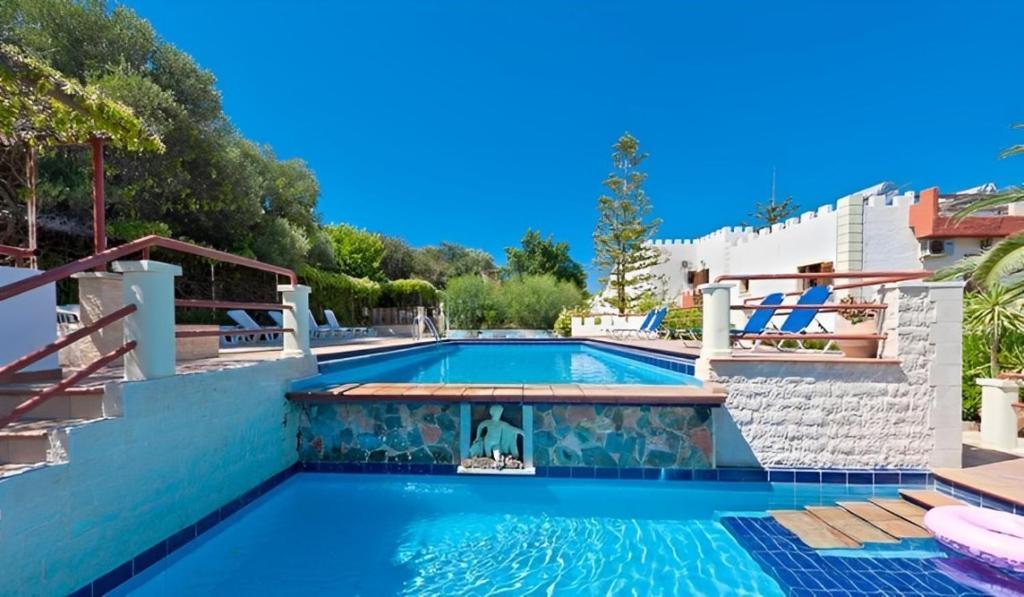 a swimming pool with blue water in a house at Cretan Castle Villas in Chania Town