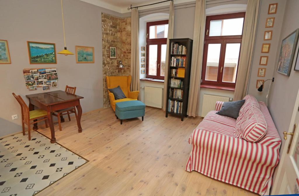 a living room with a couch and a table at Green Tree Apartment in Pécs