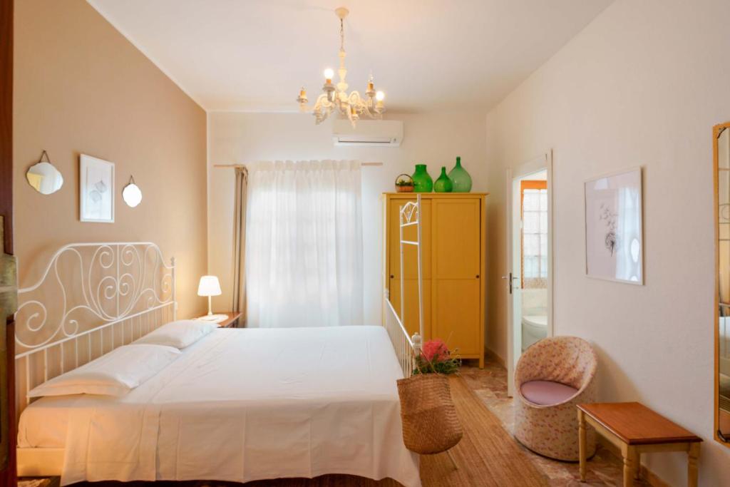 a bedroom with a white bed and a yellow cabinet at BB 1987 Pula in Pula