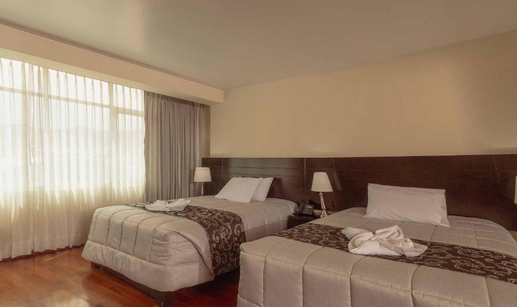 Postel nebo postele na pokoji v ubytování Group House Apart Hotel