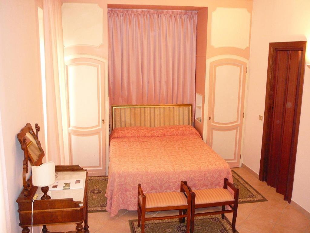 Postel nebo postele na pokoji v ubytování Hotel Umbra