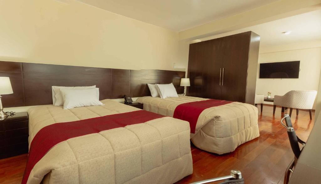 Postel nebo postele na pokoji v ubytování Group House Apart Hotel