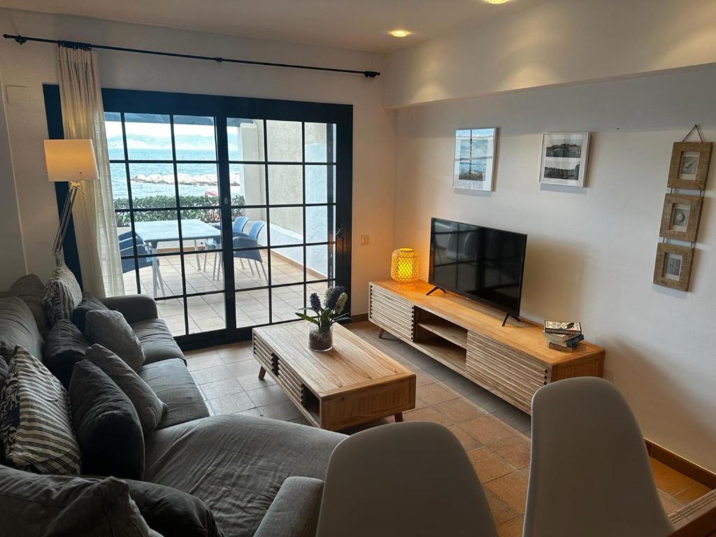 a living room with a couch and a flat screen tv at Anna in L'Escala