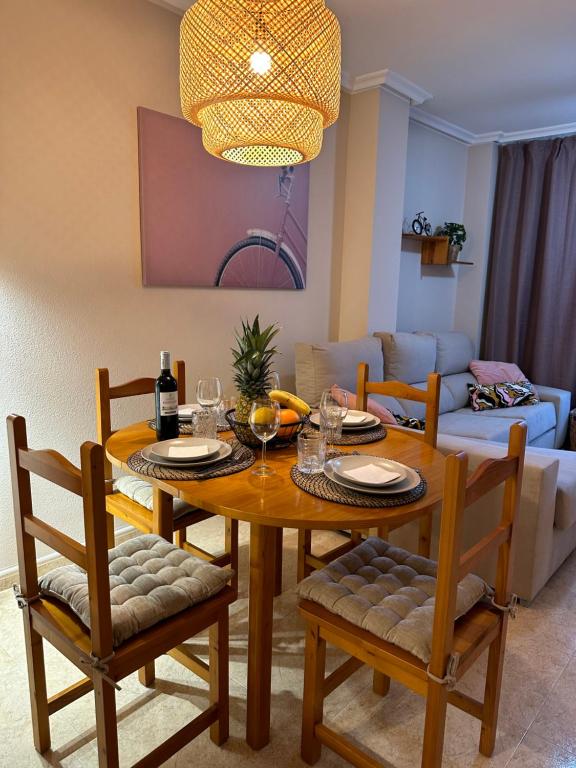 a living room with a wooden table and chairs at Sol de mar, La Mata (Hiszpania) in La Mata