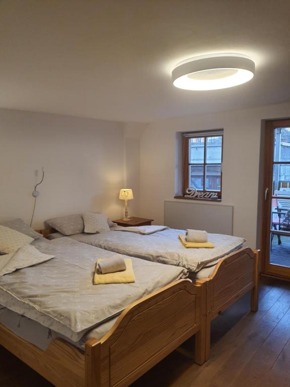 a bedroom with two beds with yellow towels on them at FeWo Sonne in Konstanz