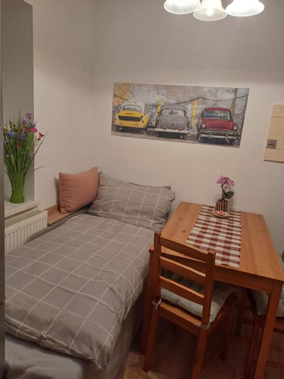 a bed and a table in a room with a table and a couch at Appartement Franz in Bad Ischl