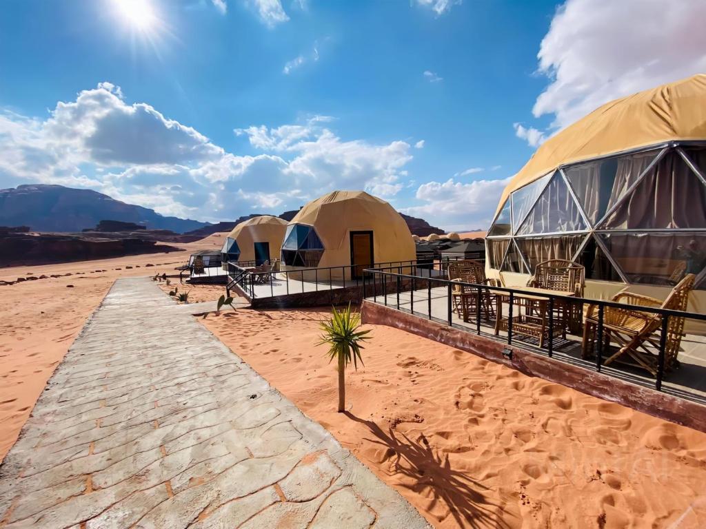 a row of luxury tents in the desert at WADI Rum STARLIGHT CAMP in Wadi Rum