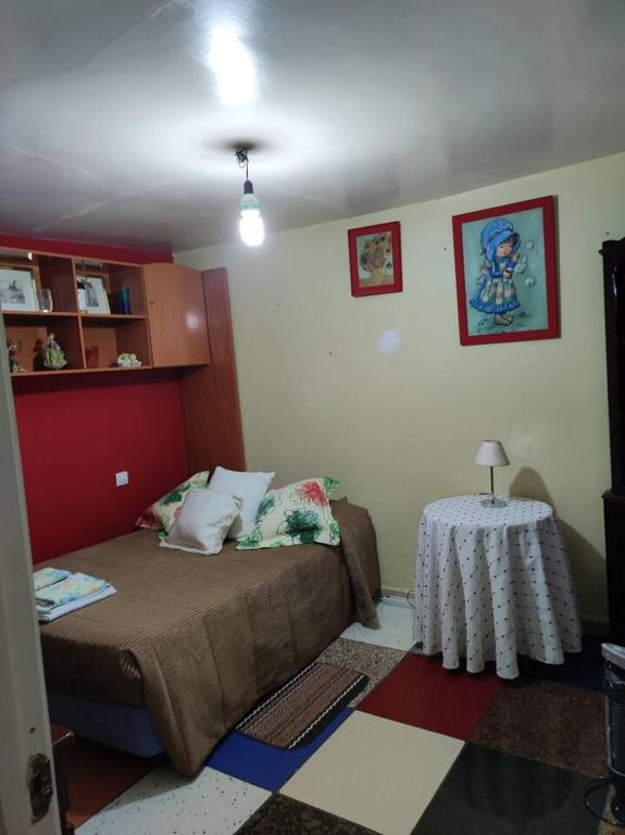 a small bedroom with a bed and a table at One bedroom house at Las Ventas Con Pena Aguilera in Ventas con Peña Aguilera