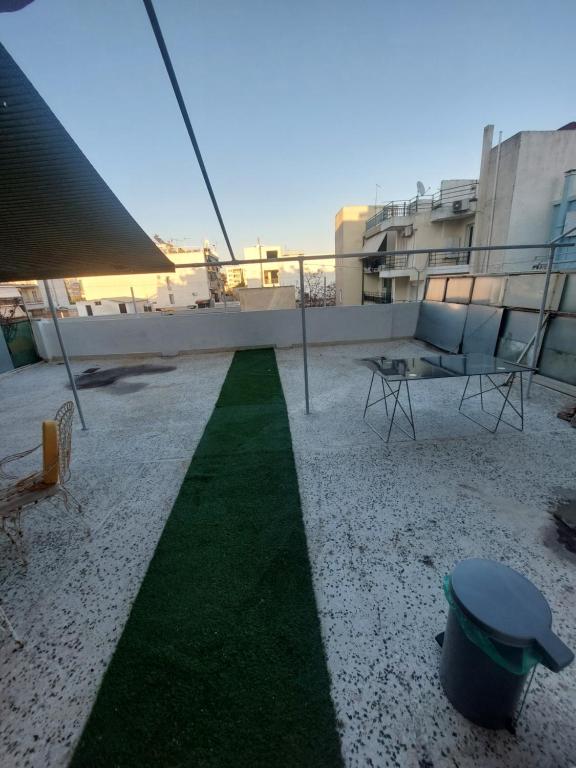 a balcony with a green lawn on a building at Maria Louiza apartment NEAR CENTER in Athens