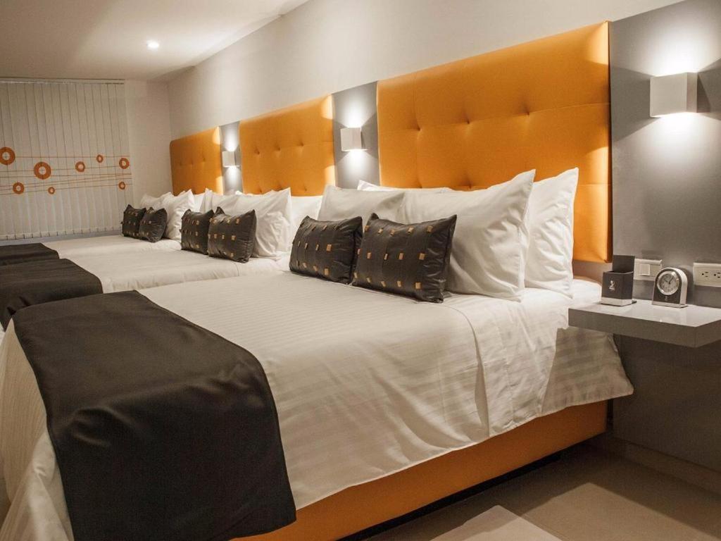 Säng eller sängar i ett rum på Hotel Dibeni Pereira
