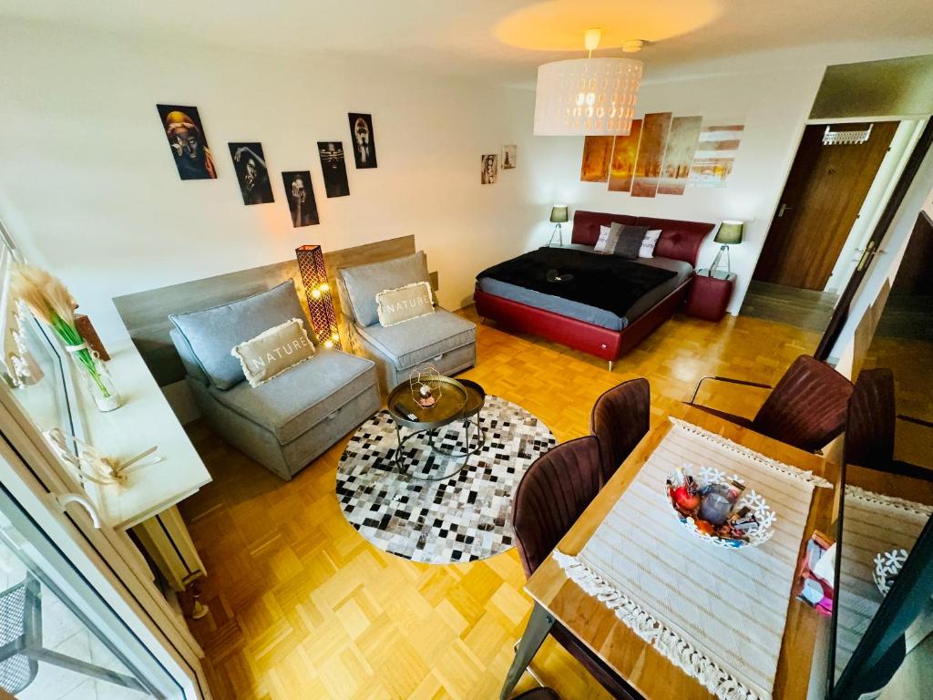 a living room with a couch and a table at Sunset View Apartment with Logia in Ettlingen
