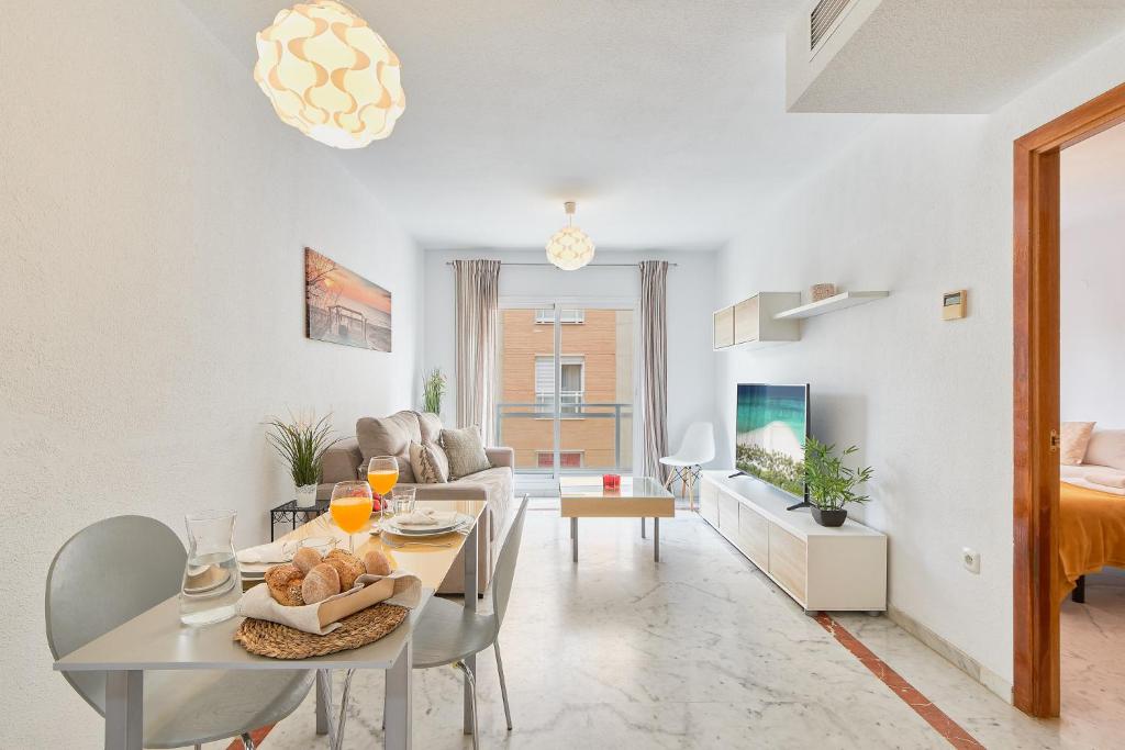 a living room with a table and a dining room at Mercy Beach in Málaga