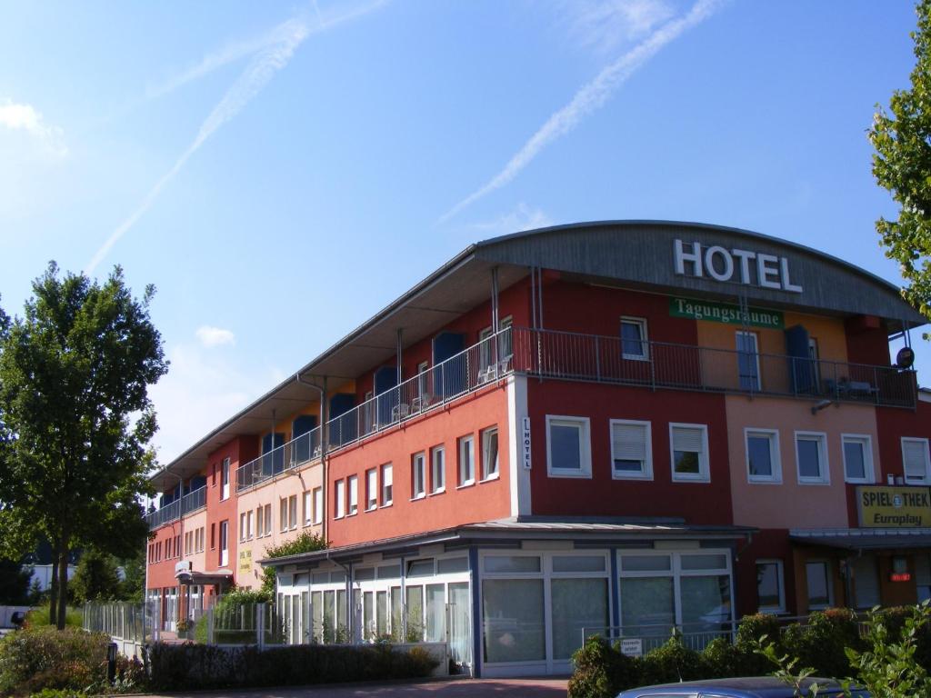 a hotel with a red building at Hotel Thannhof in Schweitenkirchen