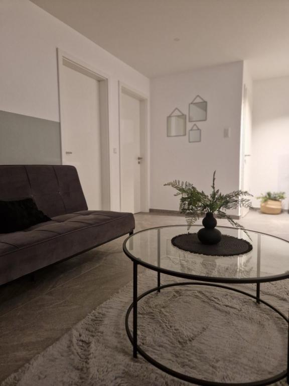 a living room with a couch and a glass table at FeWo Mösle in Lautrach