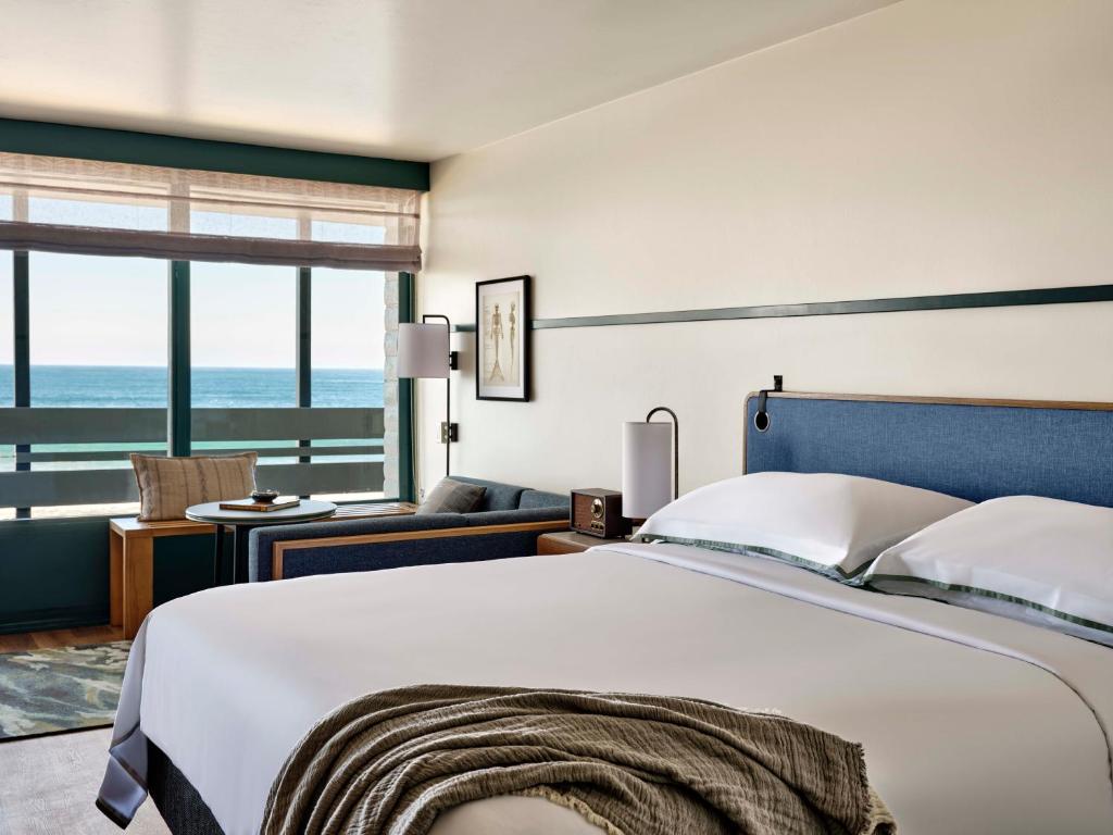 a bedroom with a bed and a view of the ocean at Monterey Tides in Monterey