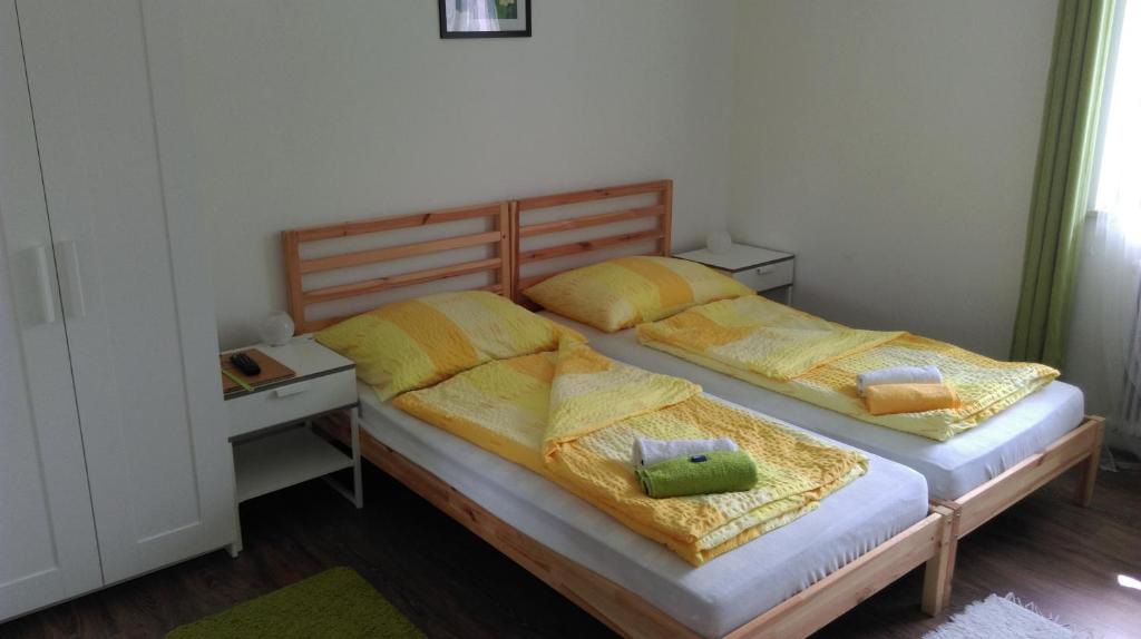 2 Einzelbetten in einem Schlafzimmer mit gelben Decken in der Unterkunft Gasthof Papillon in Möderbrugg