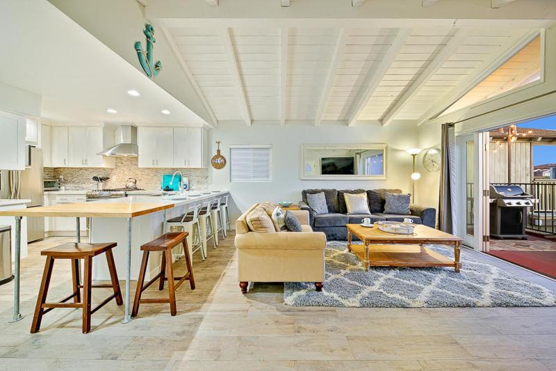 a kitchen and living room with a couch and a table at 2 Story Home with Rooftop Deck next to the Bay & Beach in Newport Beach