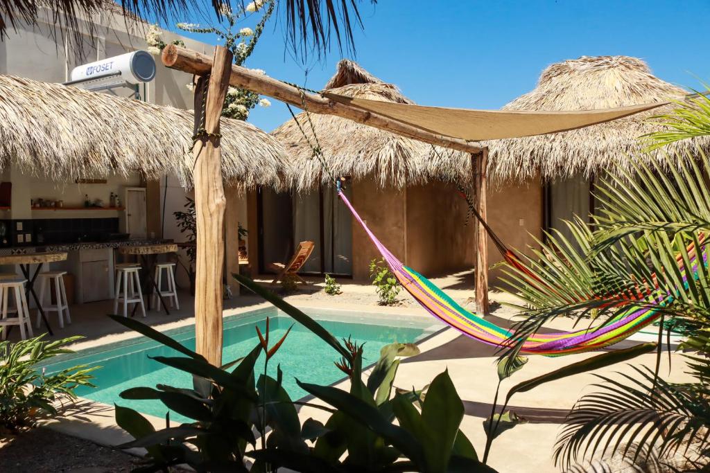 a resort with a hammock and a swimming pool at Casa Terra in Paso Hondo