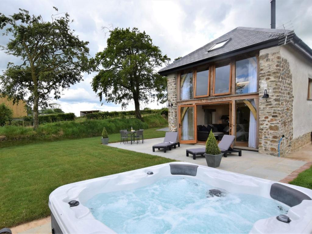 a hot tub in the yard of a house at 1 Bed in Dulverton 59339 in Knowstone