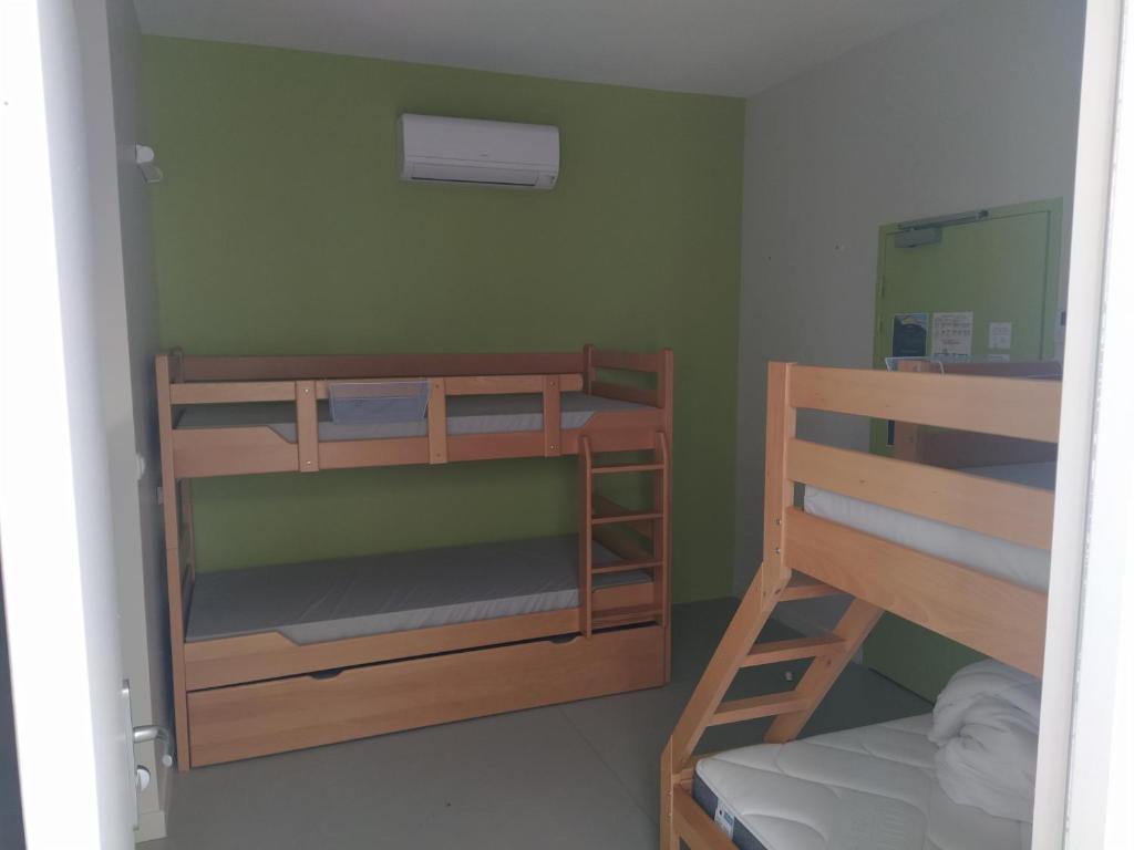 a room with two bunk beds and a mirror at Le Préau de Baix in Baix