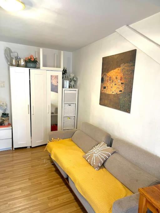 a living room with a couch with a yellow blanket at Apartment near Central Station in Zurich