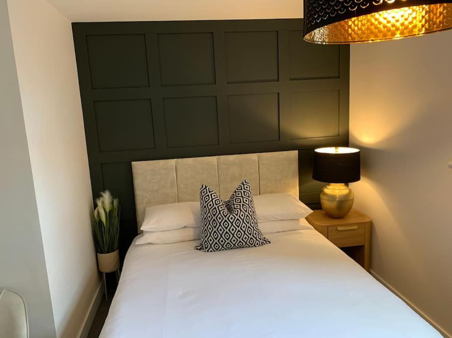 a bedroom with a white bed with two pillows on it at Waterfront view apartment in Lincolnshire