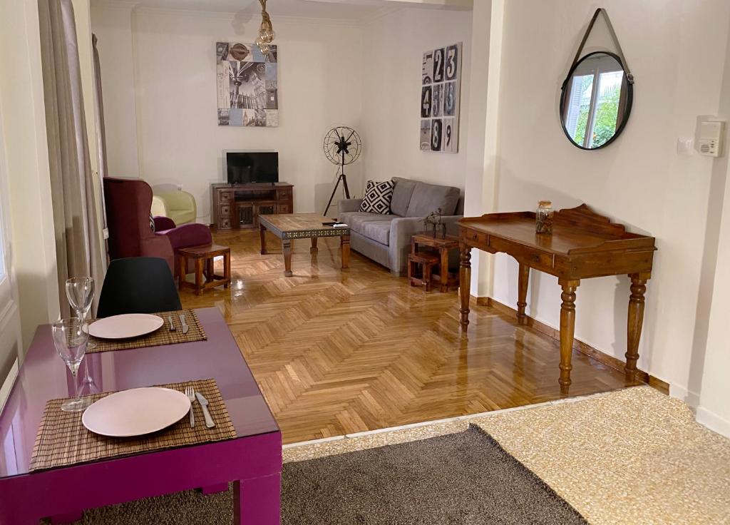 een woonkamer met een bank en een tafel bij Spacious 2 BR apartment Downtown Athens - Explore Center by foot in Athene