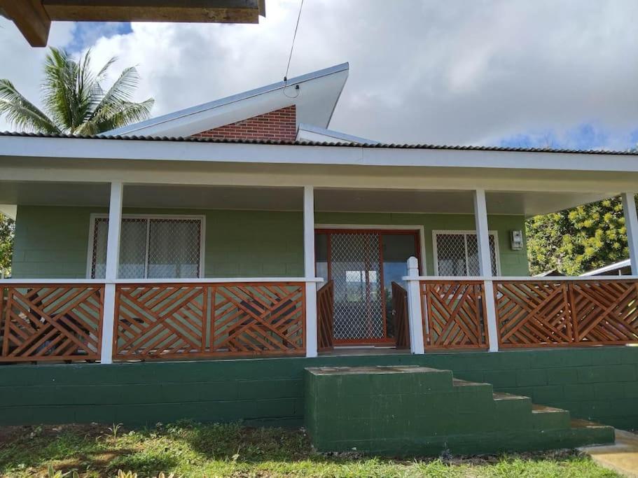 a house with a wooden fence in front of it at Fale Mailani-2 rooms/AC/hotwater in Vaitele