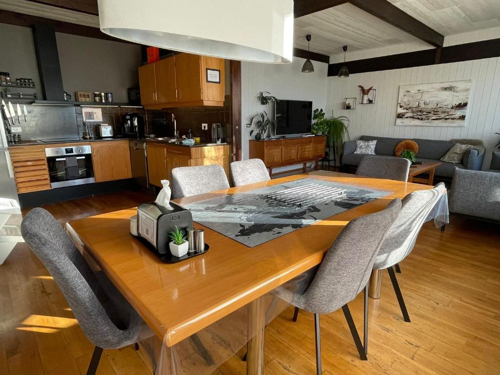 a kitchen and dining room with a wooden table and chairs at Haukaberg House in Höfn