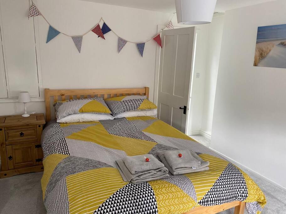 una camera da letto con un letto con due cappelli sopra di Holmfirth Hideout a Holmfirth