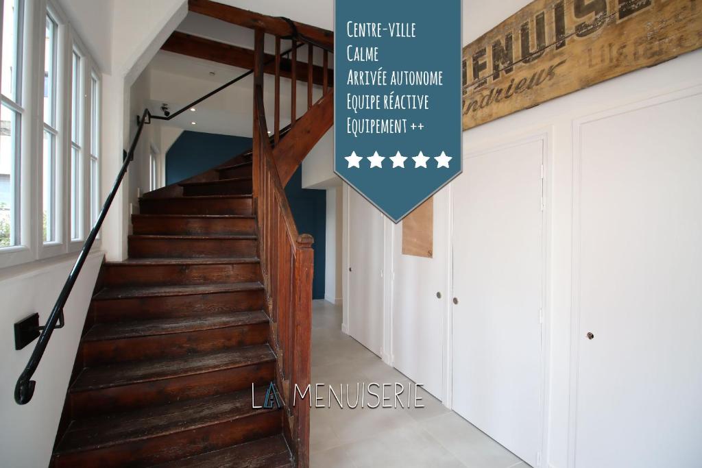 a staircase in a house with a sign that reads come till cape harlequin at La Menuiserie in Gap