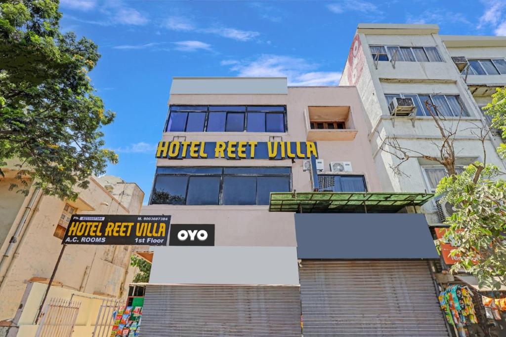 a building with a hotel respect villa sign on it at OYO Flagship Hotel Reet Villa in Ahmedabad